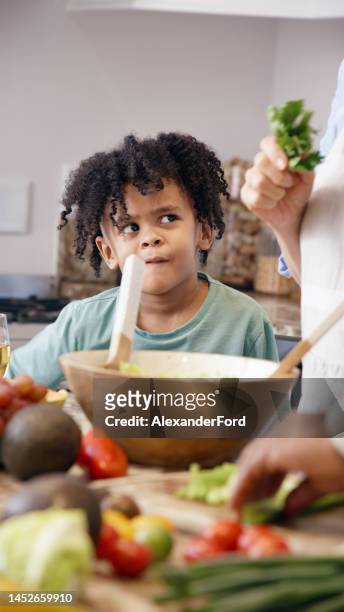 cooking, confused and child with grandparents for lunch, food nutrition and diet salad in the kitchen.  doubt, learning and african kid with family for dinner or breakfast with vegetables in a house - lady cooking confused imagens e fotografias de stock