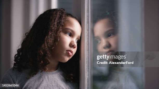 mental health, girl and window for sad, thinking and depressed in home. depression, black child and unhappy with stress, anxiety and frustrated with suffering, disappointed and foster female kid. - kindertijd stockfoto's en -beelden