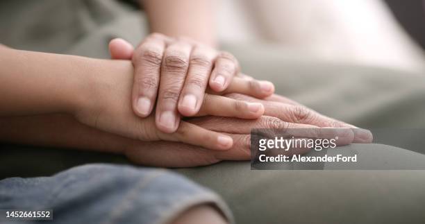 holding hands, support and people hands together for trust, love and hope of friends or couple. faith, helping or sorry gesture of a person in rehabilitation therapy together with solidarity and help - un certain regard stock pictures, royalty-free photos & images