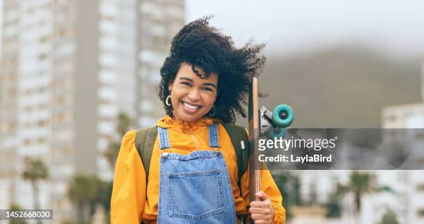 young black woman, skateboard and urban in city portrait, smile and trendy skateboarder, happy in los angeles. young, african american gen z youth in wind and skateboarding, happy in cityscape. - african american women in the wind stock pictures, royalty-free photos & images