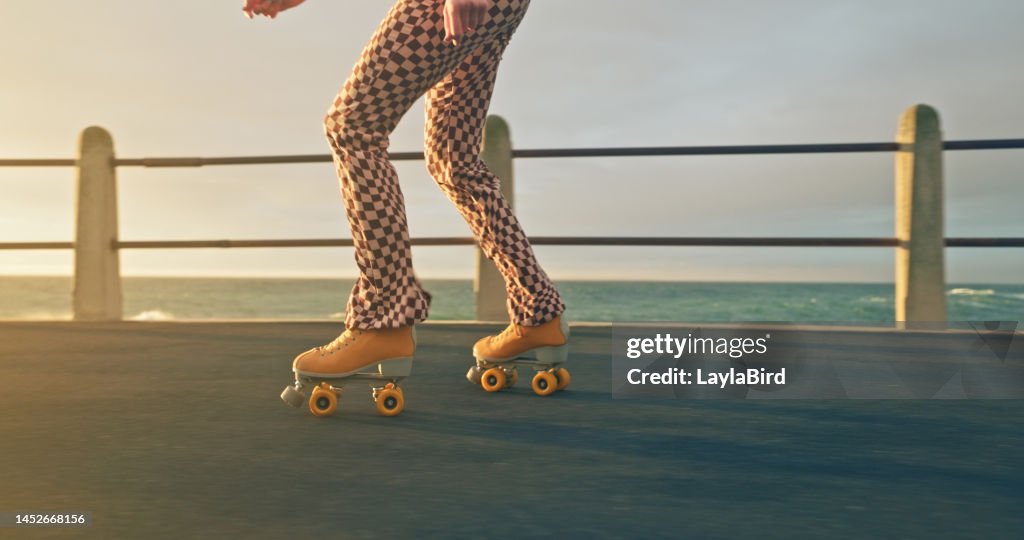 Woman roller skating, sport and fitness on beach sidewalk, sea or ocean shore. Hobby, exercise and sports with roller skate cardio workout, training for wellness, strength and health on promenade