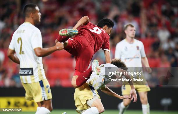 Hiroshi Ibusuki of Adelaide United heads over Mark Natta of Newcastle Jets towards goal during the round nine A-League Men's match between Adelaide...