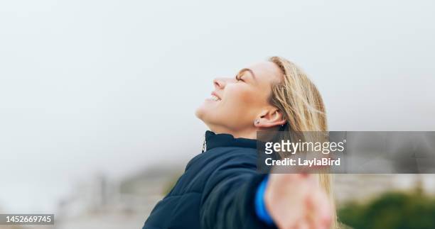happy woman, outdoor freedom arms out in wind, breathe fresh air or purpose, happiness and motivation, peace and dream, calm or hope. smile lady, optimism and relax in nature, wellness or mindfulness - woman with arms outstretched stock pictures, royalty-free photos & images