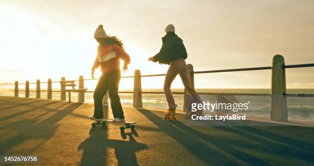 women, skateboard and vacation with friends at sunset while skating for fun, adventure and travel on promenade at sea. females together for skate exercise, freedom and skateboarding outdoor in summer - extreme skating stock pictures, royalty-free photos & images