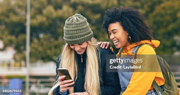 social media, smartphone and funny meme with friends laughing, comic and technology, students on los angeles college campus. young women, social network and comedy on internet, online and web connect - campus life stock pictures, royalty-free photos & images