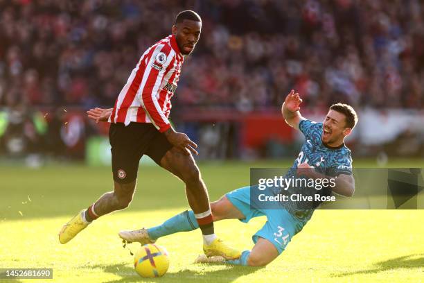 Clement Lenglet of Tottenham Hotspur is challenged by Ivan Toney of Brentford during the Premier League match between Brentford FC and Tottenham...