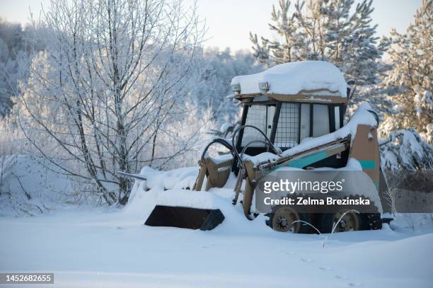 winter landscape with a snow-covered tractor,  abandoned place near fore - brezinska stock pictures, royalty-free photos & images