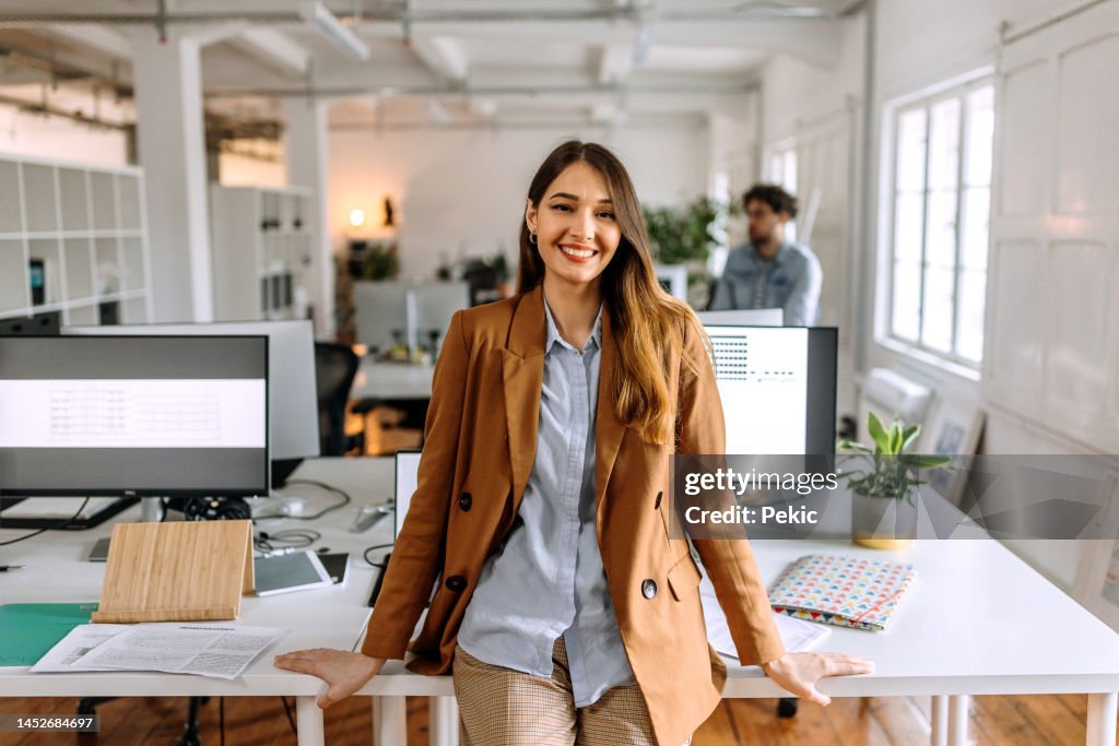 Portrait of young beautiful casually clothed woman in the modern office