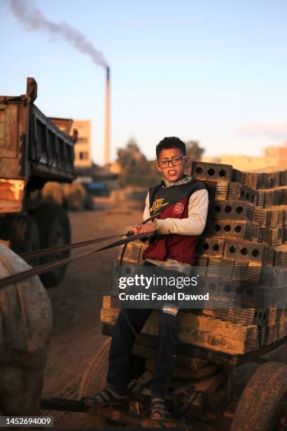 Children works in brick factories on December 26, 2022 in Fayoum, Egypt. According to an estimate issued by the International Labor Organization in...