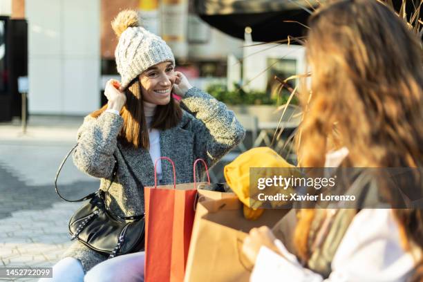 two young female friends enjoying new shopping clothes - shopping excitement stock pictures, royalty-free photos & images