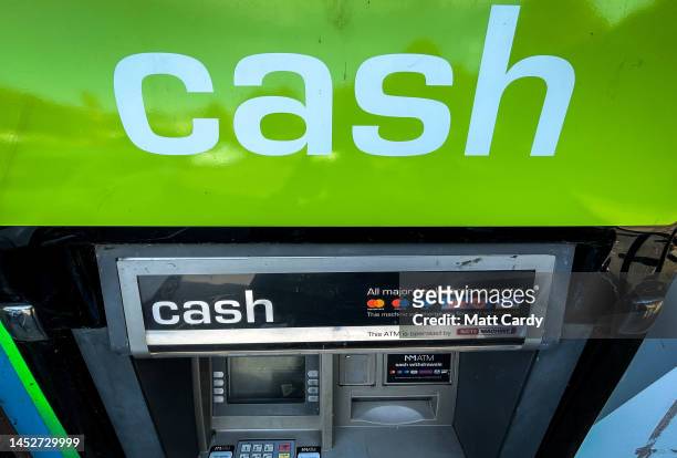 The word cash is displayed above a ATM cash dispenser, on October 11, 2022 in Bristol, England. The UK is currently facing a cost of living crisis,...