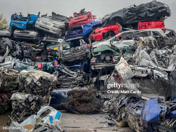 End of life petrol and diesel cars and vans are piled on top of one another as they wait to be recycled in a car scrapyard on November 29, 2022 in...