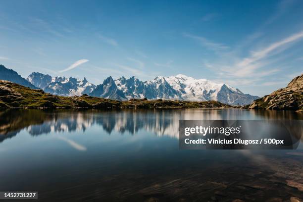 scenic view of lake by mountains against sky,mont blanc massif,chamonix,france - mountain sky photos et images de collection