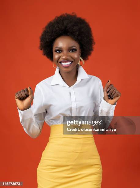 happy lady on bright outfit and afro hair - beautiful nigerian women stock pictures, royalty-free photos & images