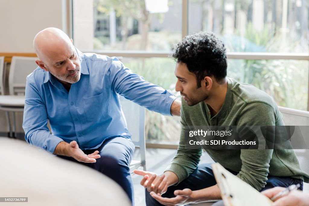 Mature man helps younger man verbalize problems in therapy