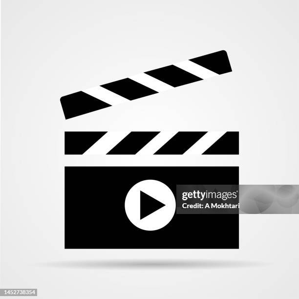 cinema clapperboard icon with play button. - clapboard stock illustrations