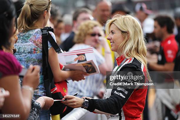 Maria de Villota of Spain and Marussia signs autographs for fans during previews to the Monaco Formula One Grand Prix at the Monte Carlo Circuit on...