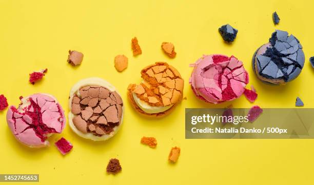 broken round macarons with crumbs on a yellow background,delicious dessert,top view,ukrainian village,united states,usa - maräng bildbanksfoton och bilder