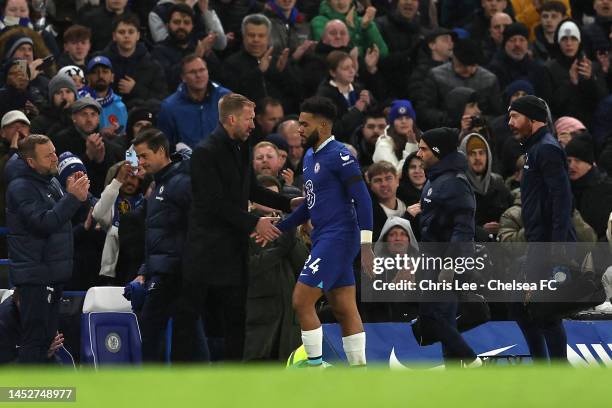 Reece James of Chelsea shakes hands with Graham Potter, Head Coach of Chelsea as they go off injured during the Premier League match between Chelsea...