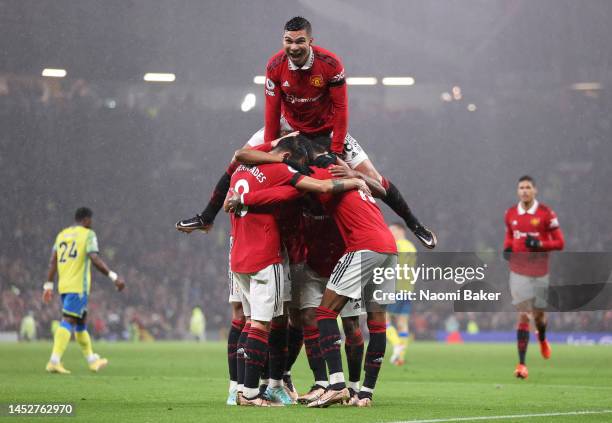 Anthony Martial of Manchester United celebrates with Casemiro and team mates after scoring their side's second goal during the Premier League match...