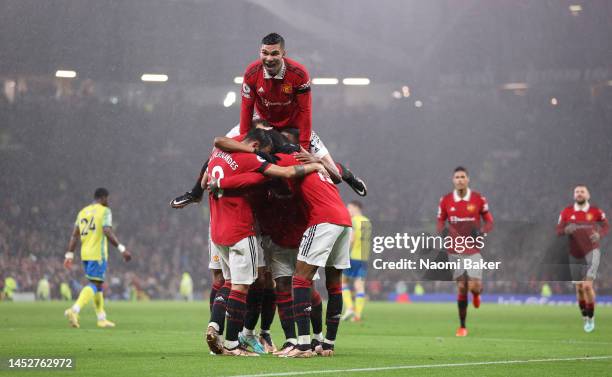 Anthony Martial of Manchester United celebrates with Casemiro and team mates after scoring their side's second goal during the Premier League match...