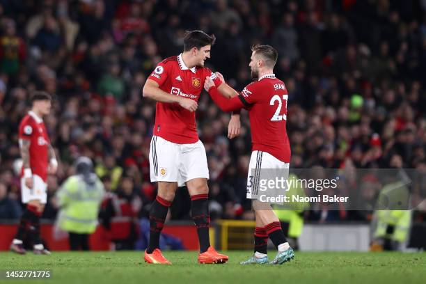 Harry Maguire of Manchester United is handed the captains armband by Luke Shaw during the Premier League match between Manchester United and...