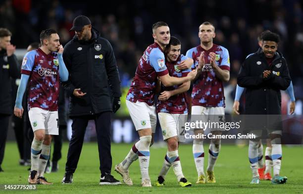 Taylor Harwood-Bellis, Josh Cullen and Jordan Beyer of Burnley applaud the fans after their victory in the Sky Bet Championship between Burnley and...