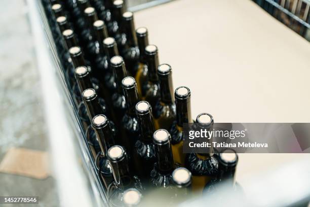winery, alcohol production. wine bottles in liquor store - iron wine stock pictures, royalty-free photos & images