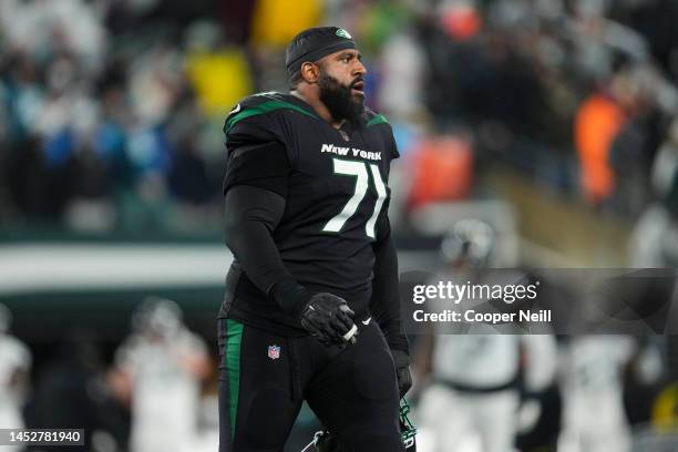 Duane Brown of the New York Jets walks onto the field against the Jacksonville Jaguars at MetLife Stadium on December 22, 2022 in East Rutherford,...