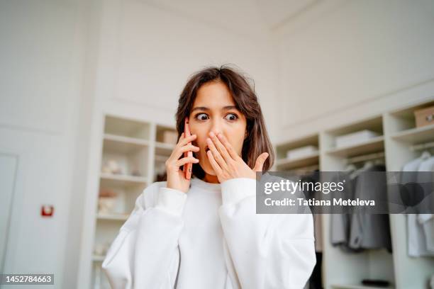 bad news on phone call, work failure. shock news, rumors and gossip calling. worried female have a secret conversation on the mobile phone in the clothes store - gossip stock pictures, royalty-free photos & images