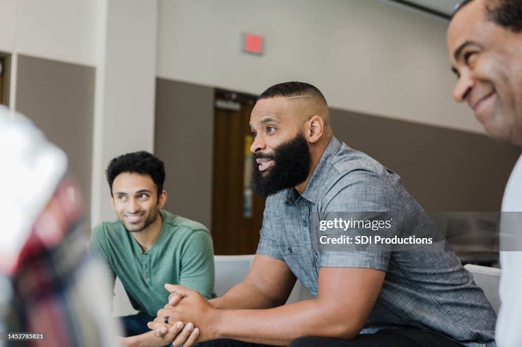 Diverse smile during support group meeting