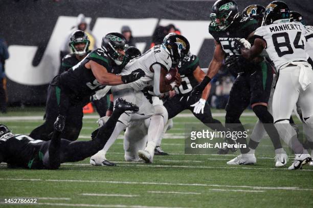 Defensive Lineman Soloman Thomas of the New York Jets stops the run in the Thursday Night Football game in the rain between the Jacksonville Jaguars...