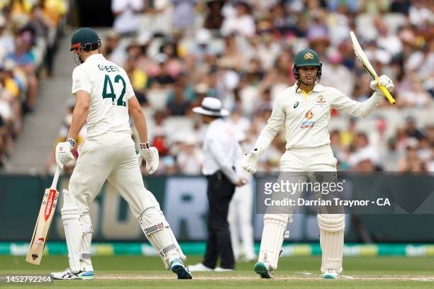 Alex Carey of Australia raises his bat after scoring 50 runs during day three of the Second Test match in the series between Australia and South...