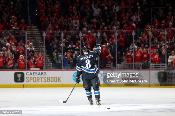 Alex Ovechkin of the Washington Capitals salutes the fans after scoring his 802nd career goal during a game against the Winnipeg Jets at Capital One...