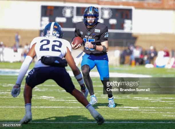 Cole Snyder of the Buffalo Bulls runs the ball towards Marc Stampley II of the Georgia Southern Eagles during the second half of the Tax Act Camelia...