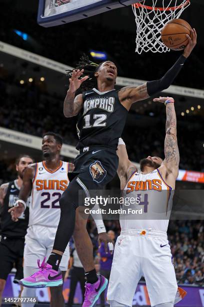 Ja Morant of the Memphis Grizzlies goes to the basket during the first half against Duane Washington Jr. #4 of the Phoenix Suns at FedExForum on...