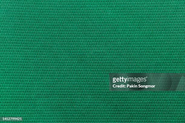 green color sports clothing fabric football shirt jersey texture and textile background. - pro to pro textile stock pictures, royalty-free photos & images