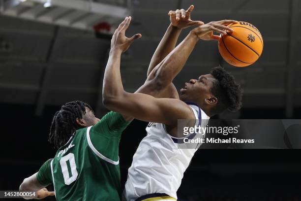Ven-Allen Lubin of the Notre Dame Fighting Irish shot is blocked by Omar Payne of the Jacksonville Dolphins during the second half at Purcell...