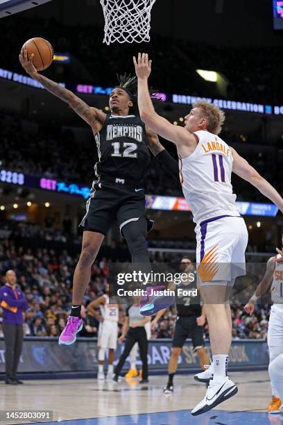 Ja Morant of the Memphis Grizzlies goes to the basket against Jock Landale of the Phoenix Suns during the first half at FedExForum on December 27,...