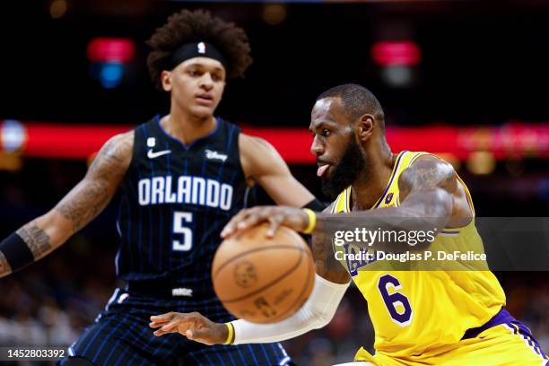 LeBron James of the Los Angeles Lakers dribbles the ball against the Orlando Magic during the third quarter at Amway Center on December 27, 2022 in...