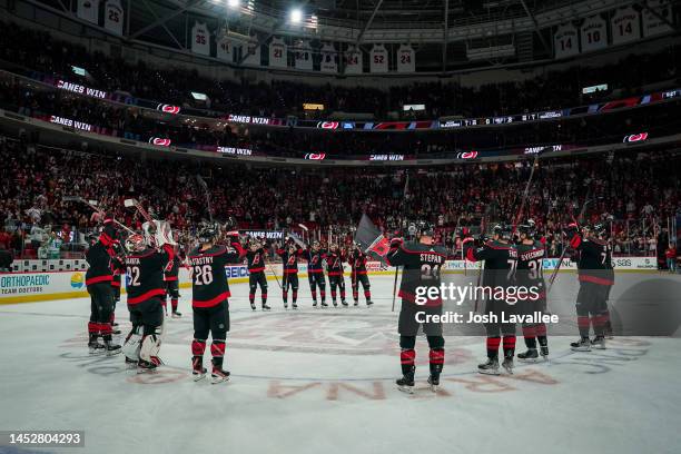 The Carolina Hurricanes celebrate with the Storm Surge after defeating the Chicago Blackhawks at PNC Arena on December 27, 2022 in Raleigh, North...