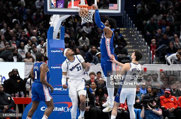Joel Embiid of the Philadelphia 76ers dunks the ball in the fourth quarter against Daniel Gafford and Deni Avdija of the Washington Wizards at...