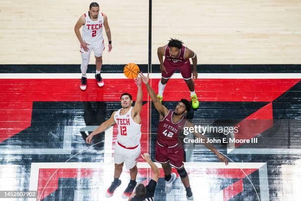 Forward Daniel Batcho of the Texas Tech Red Raiders wins the tip-off against center Dallas James of the South Carolina State Bulldogs during the...