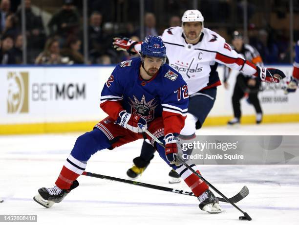 Filip Chytil of the New York Rangers controls the puck as Alex Ovechkin of the Washington Capitals loses his stick while defending during the game at...