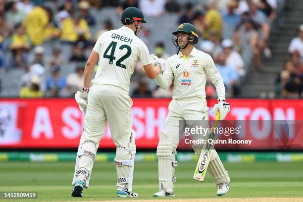 Alex Carey of Australia celebrates with Cameron Green after scoring a century during day three of the Second Test match in the series between...