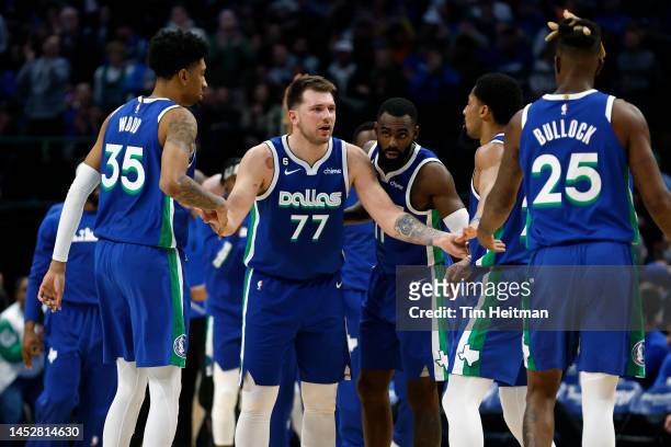 Luka Doncic of the Dallas Mavericks talks with his teammates during a timeout in the second half against the New York Knicks at American Airlines...