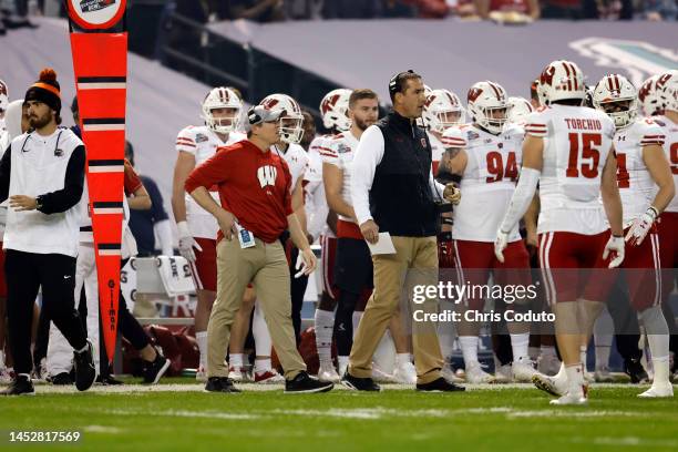 Head coach Luke Fickell and defensive coordinator Jim Leonhard of the Wisconsin Badgers on the sideline during the first half of the Guaranteed Rate...