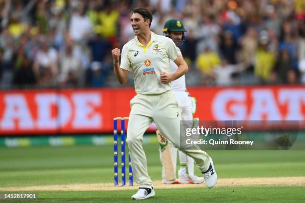 Pat Cummins of Australia celebrates dismissing Dean Elgar of South Africa during day three of the Second Test match in the series between Australia...