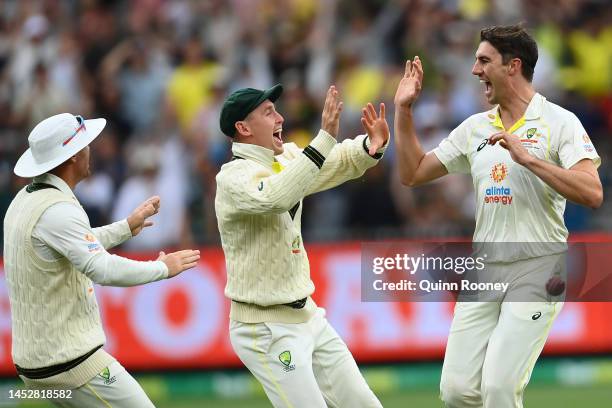 Pat Cummins of Australia celebrates dismissing Dean Elgar of South Africa during day three of the Second Test match in the series between Australia...