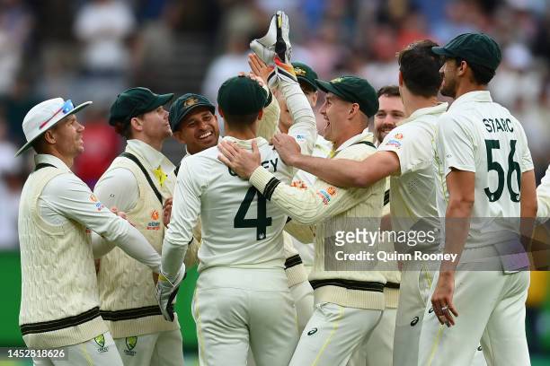 Alex Carey of Australia is congratulated by team mates after catching out Dean Elgar of South Africa during day three of the Second Test match in the...